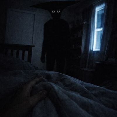 Silhouette of a figure in a dimly lit room