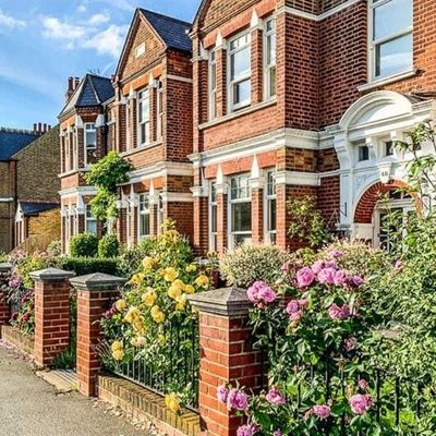 Victorian-style brick houses with vibrant gardens