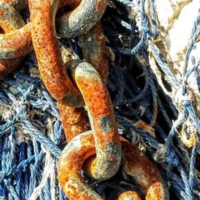 Rusty Chain Amidst Blue Nets