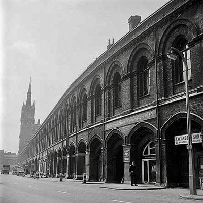 Looking south from Pancras Road along the side of St Pancras Station buildings with the tower of the south front visible in the distance.