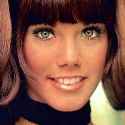 Close-up of a smiling woman with bangs