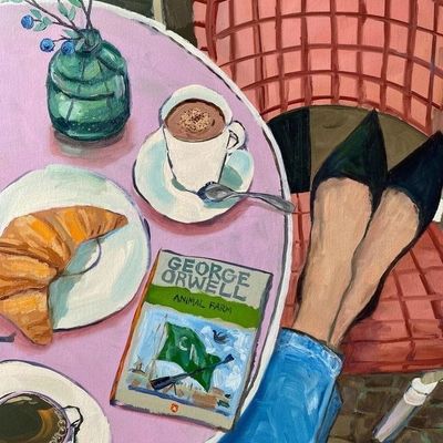 A cozy café scene with George Orwell's 'Animal Farm'
