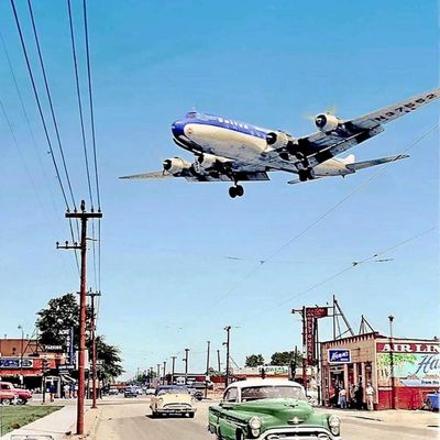 Vintage Airplane Over Urban Street