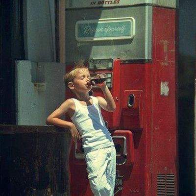 Boy Drinking from Vintage Soda Machine
