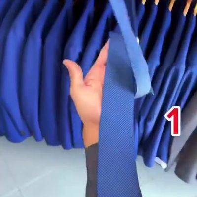 Tying a Necktie necktie hands clothing precision blue shirts
