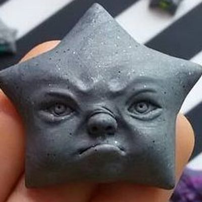 Star-Shaped Clay Sculpture of a Dog Face
