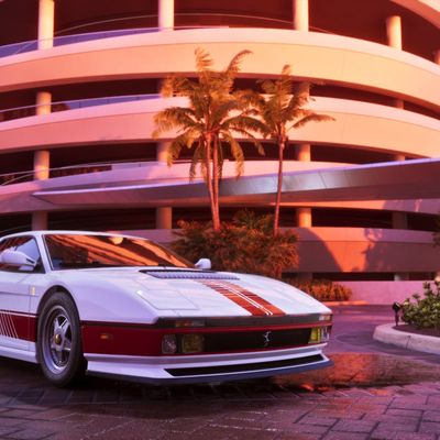GTA6 in-game screenshot outside Pegassi South Tower ferrari testarossa sports car parking garage sunset